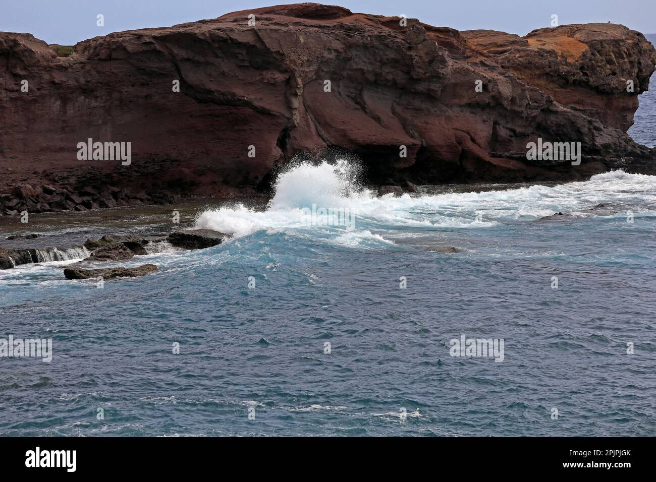 Las Coloadas red cliffs and waves. . February 2023. cym Stock Photo