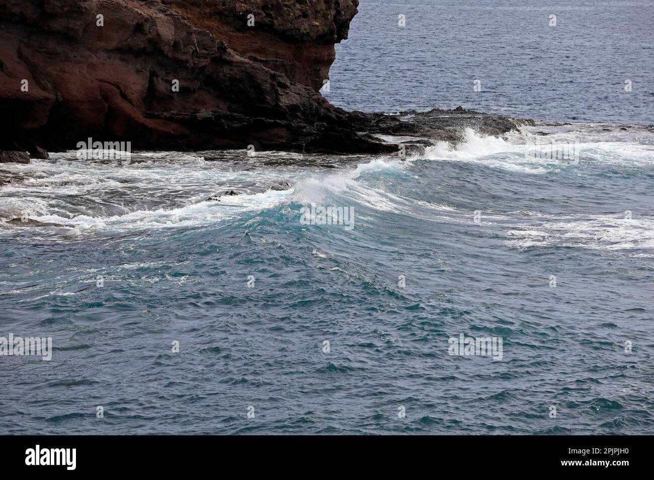 Las Coloadas red cliffs and waves. . February 2023. cym Stock Photo