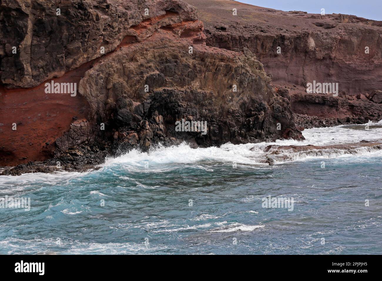 Las Coloadas red cliffs and waves. . February 2023. cym Stock Photo