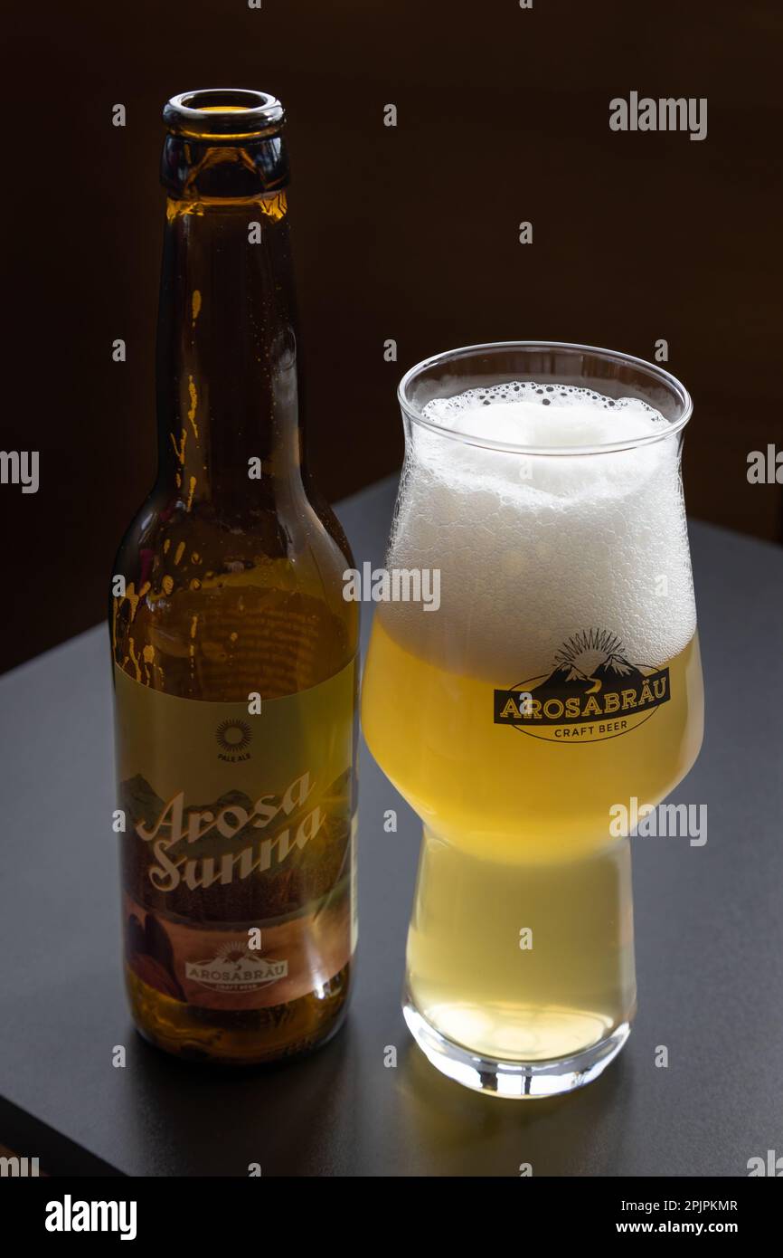 AROSA, SWITZERLAND - MARCH 03, 2023:  Bottle ands glass of Arosabrau local craft beer on table Stock Photo