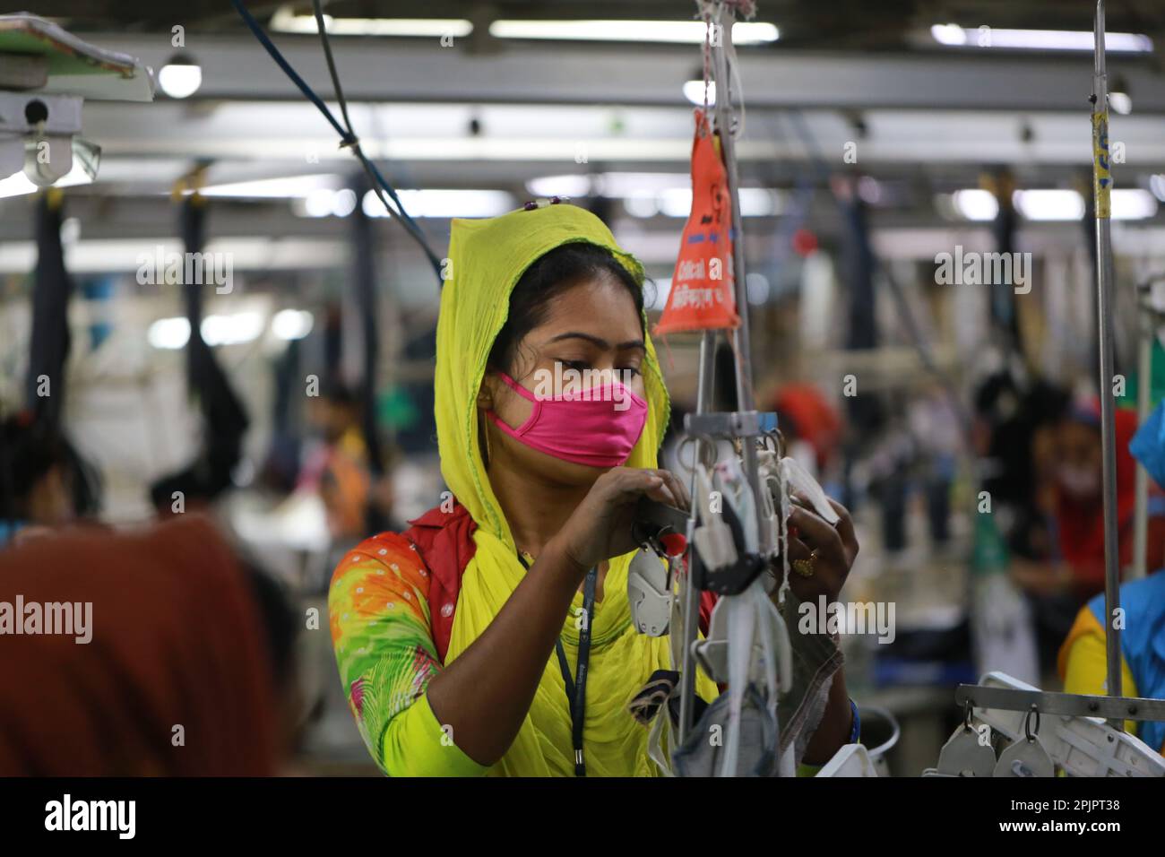 Garment workers work at a ready-made garment factory in Bangladesh. Stock Photo