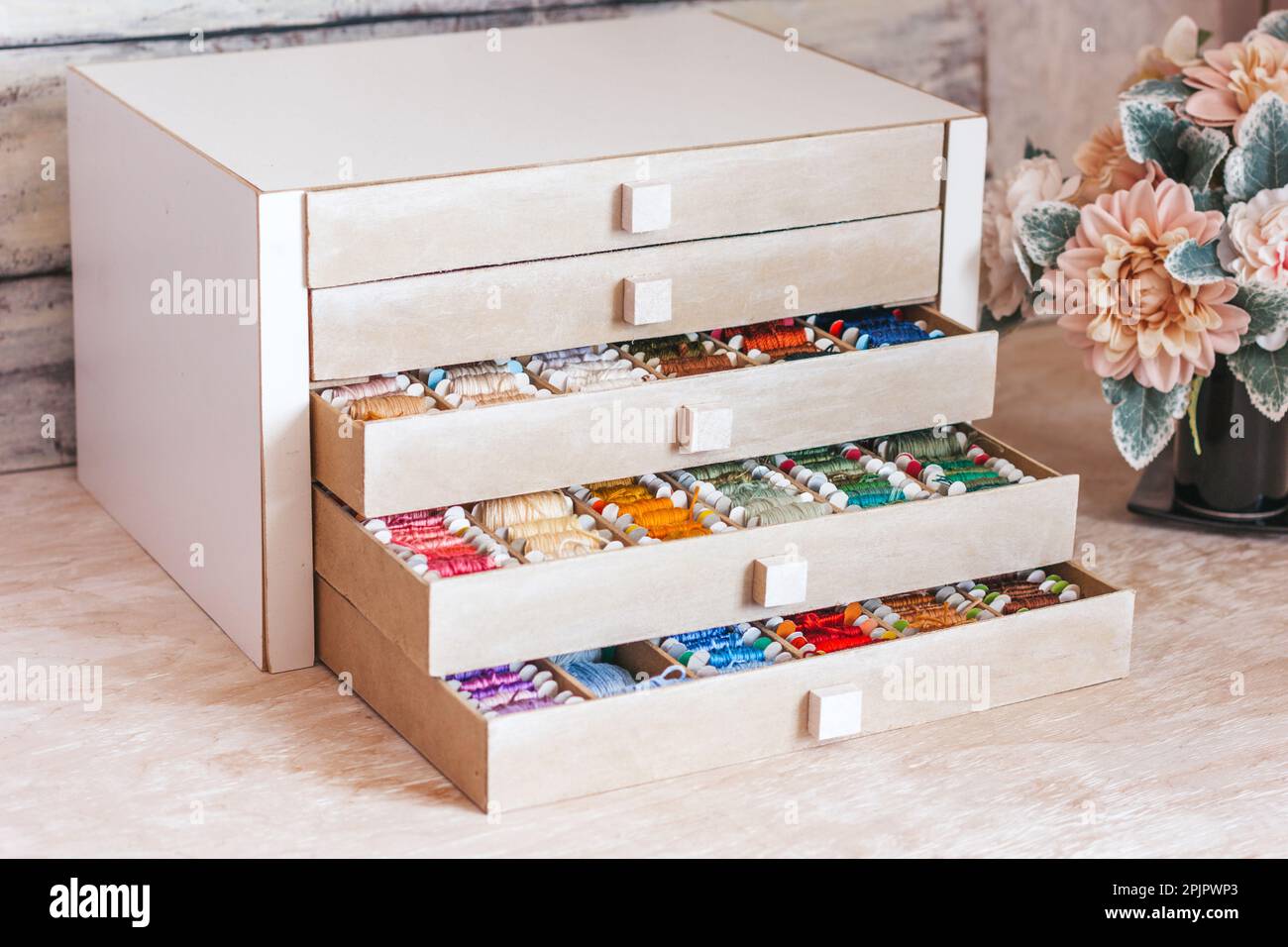 Beautiful box for threads with compartments. Beautiful colored threads in a box Stock Photo