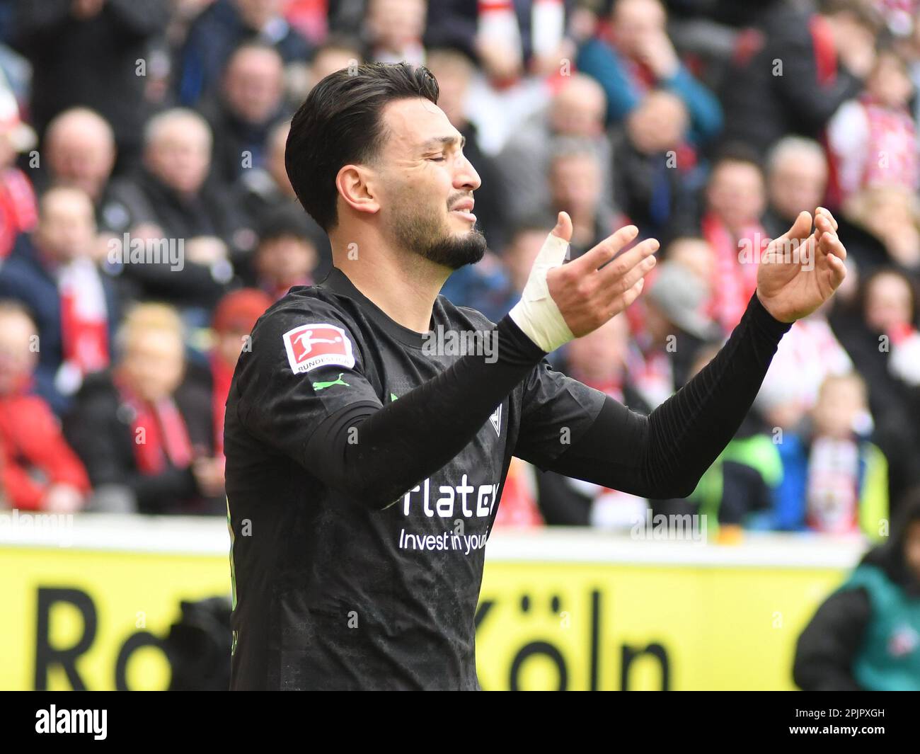 Cologne, North Rhine-Westphalia, Germany. 2nd Apr, 2023. Borussia Monchengladbach defender RAMY BENSEBAINI (25, center) is frustrated by the decision from assistant referee STEFAN LUPP (not pictured) in the FC Cologne-Borussia Monchengladbach Bundesliga match on April 2, 2023 in the RheinEnergieStadion in Cologne, Germany. (Credit Image: © Kai Dambach/ZUMA Press Wire) EDITORIAL USAGE ONLY! Not for Commercial USAGE! Stock Photo