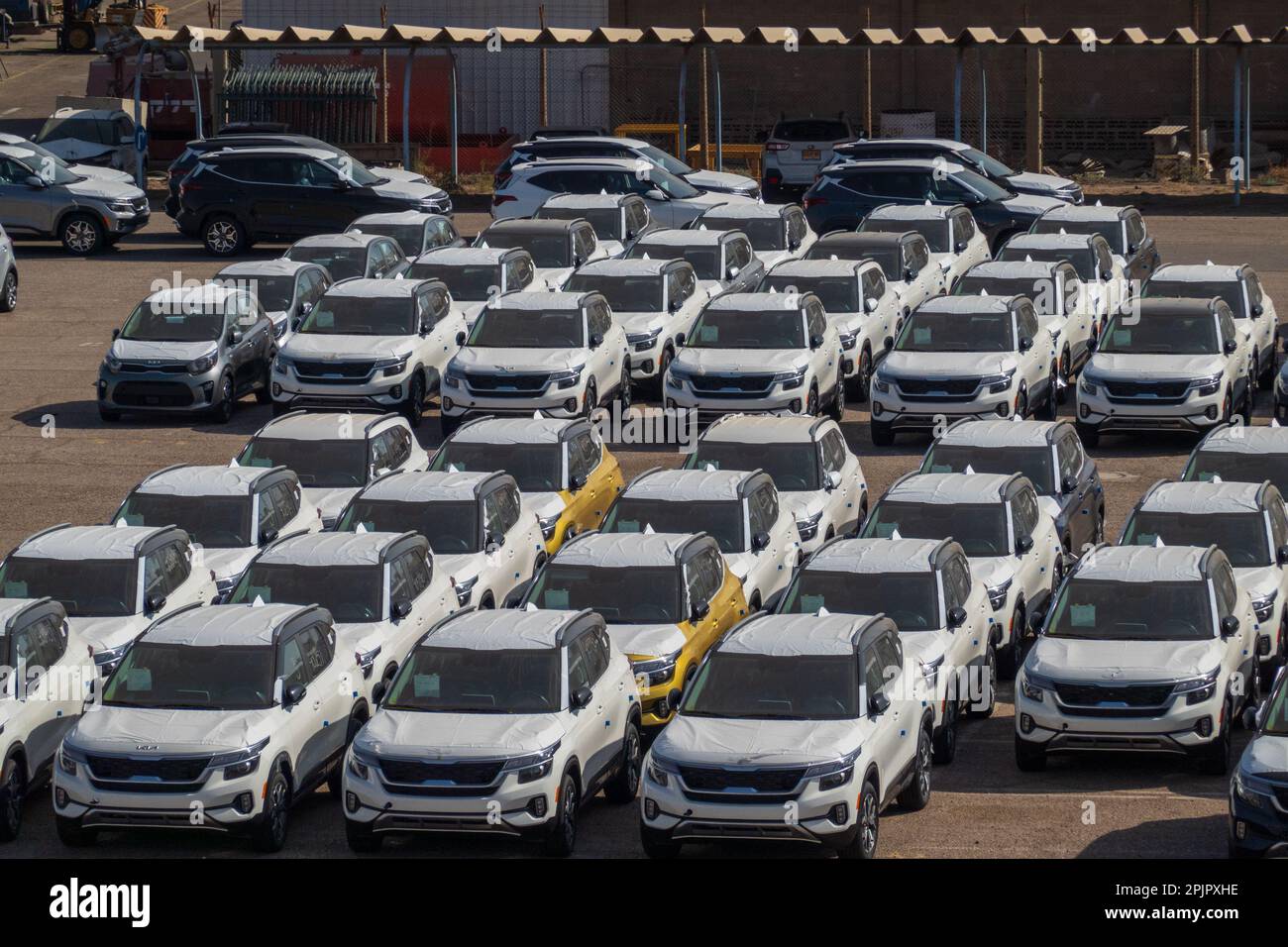 Israel Automakers Eilat, israel - November 25, 2022: High angle of many modern white ...