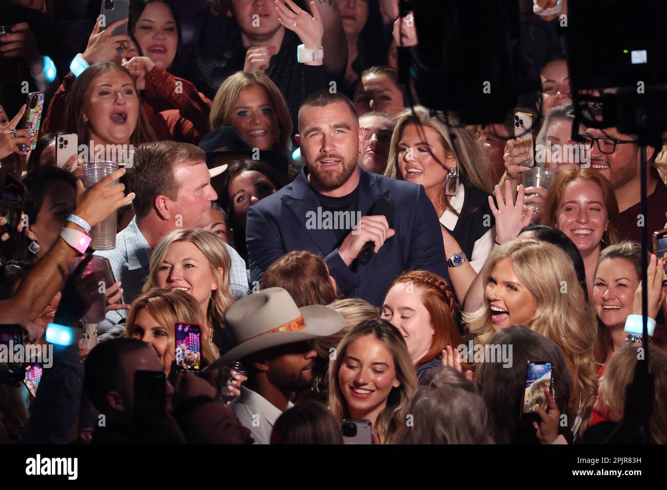 Travis Kelce Soars in Heeled Boots & Navy Suit at CMT Awards 2023 –  Footwear News