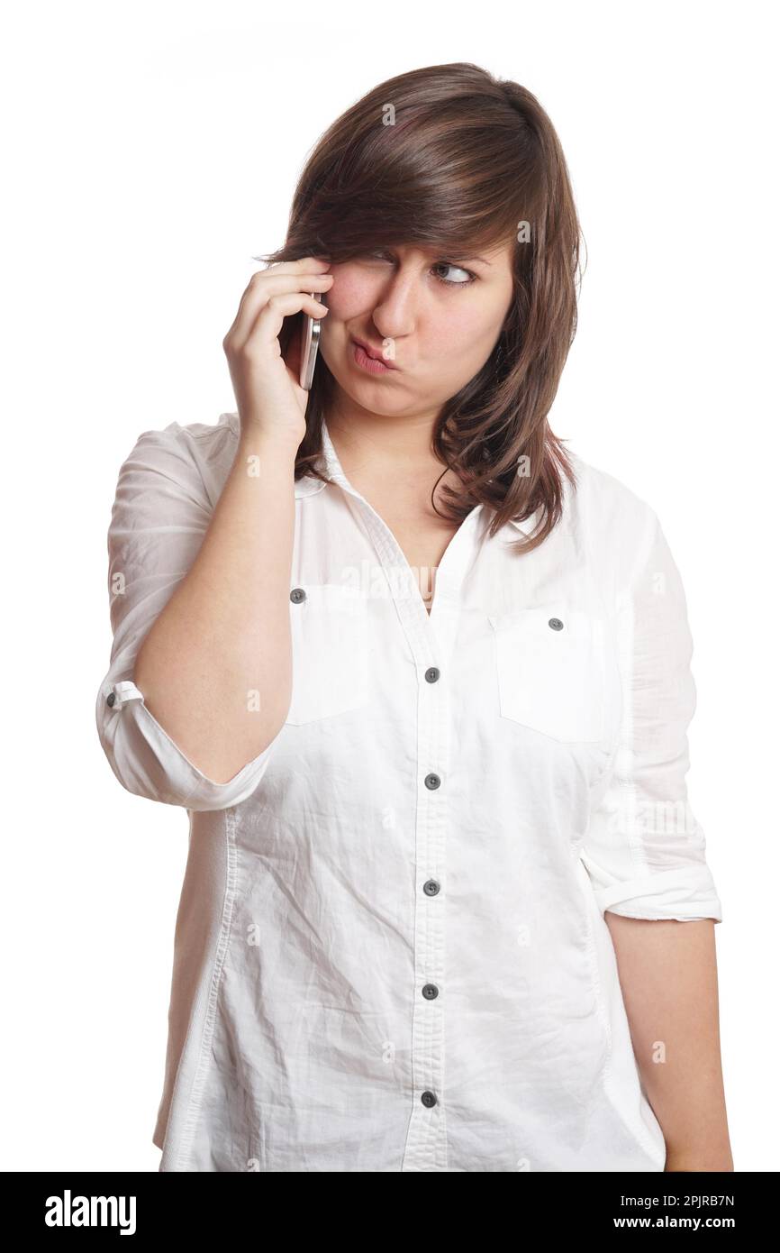 young woman making a face while on mobile phone call Stock Photo