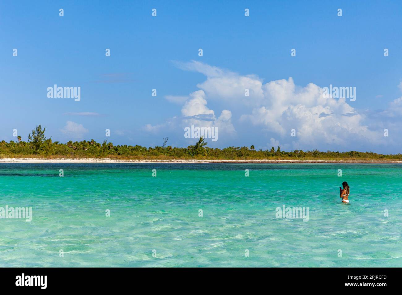 Young woman enjoying the Caribbean turquoise waters of El Cielo Bay on the island of Cozumel, Yucatán Peninsula, Mexico Stock Photo