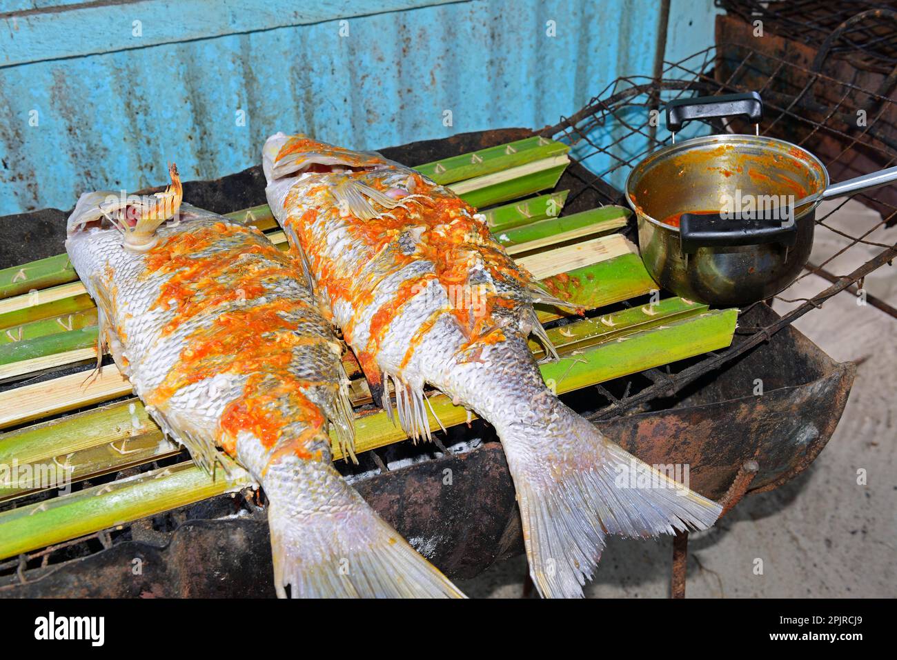 Creolestyle snapper marinated on a charcoal grill, La Digue Island