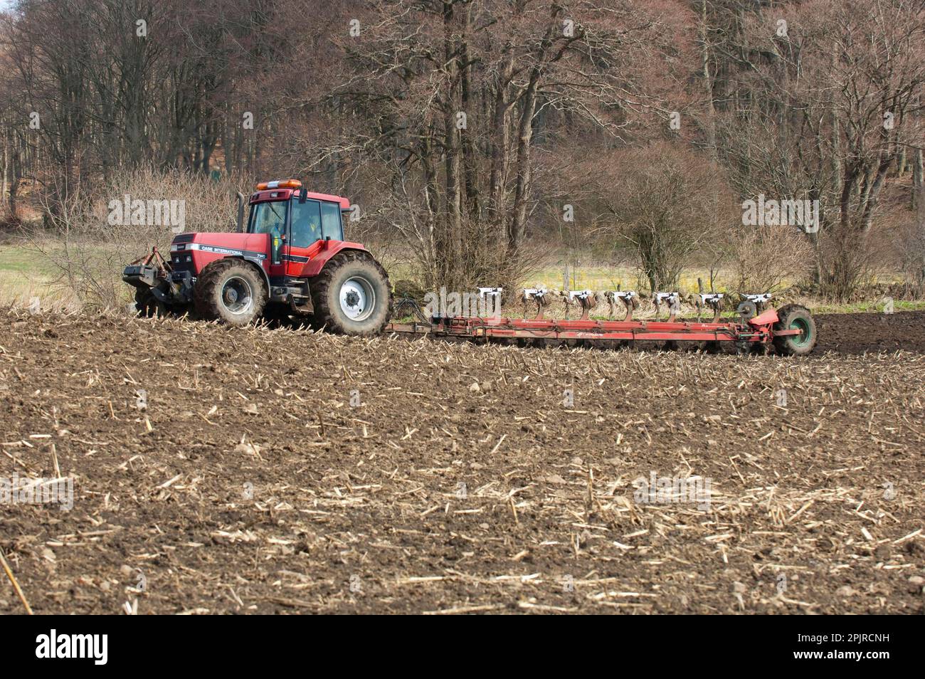 Fall Internationel 7140 tractor pulling Kverneland seven furrow plough, plough field, Skane, Sweden, spring Stock Photo