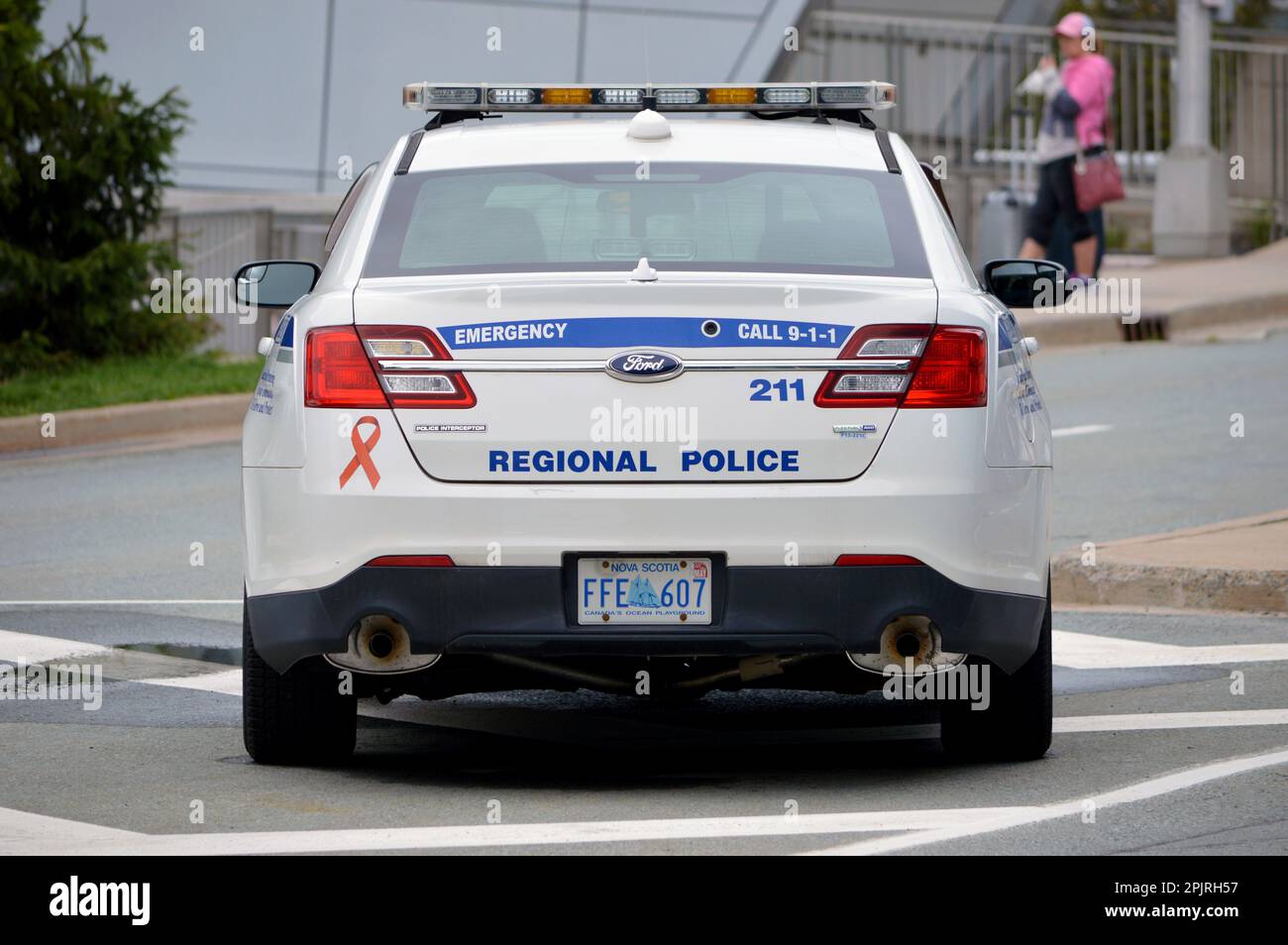 A Halifax Regional Police car, a Ford Police Interceptor, parked outside the Halifax Stanfield International Airport terminal in Nova Scotia, Canada Stock Photo