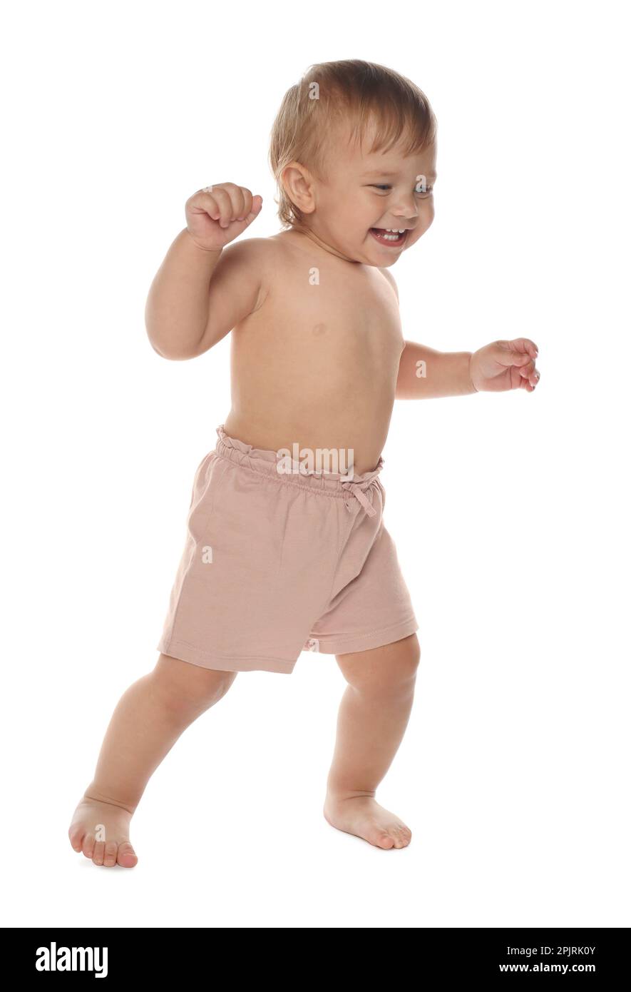 Cute baby in shorts learning to walk on white background Stock Photo