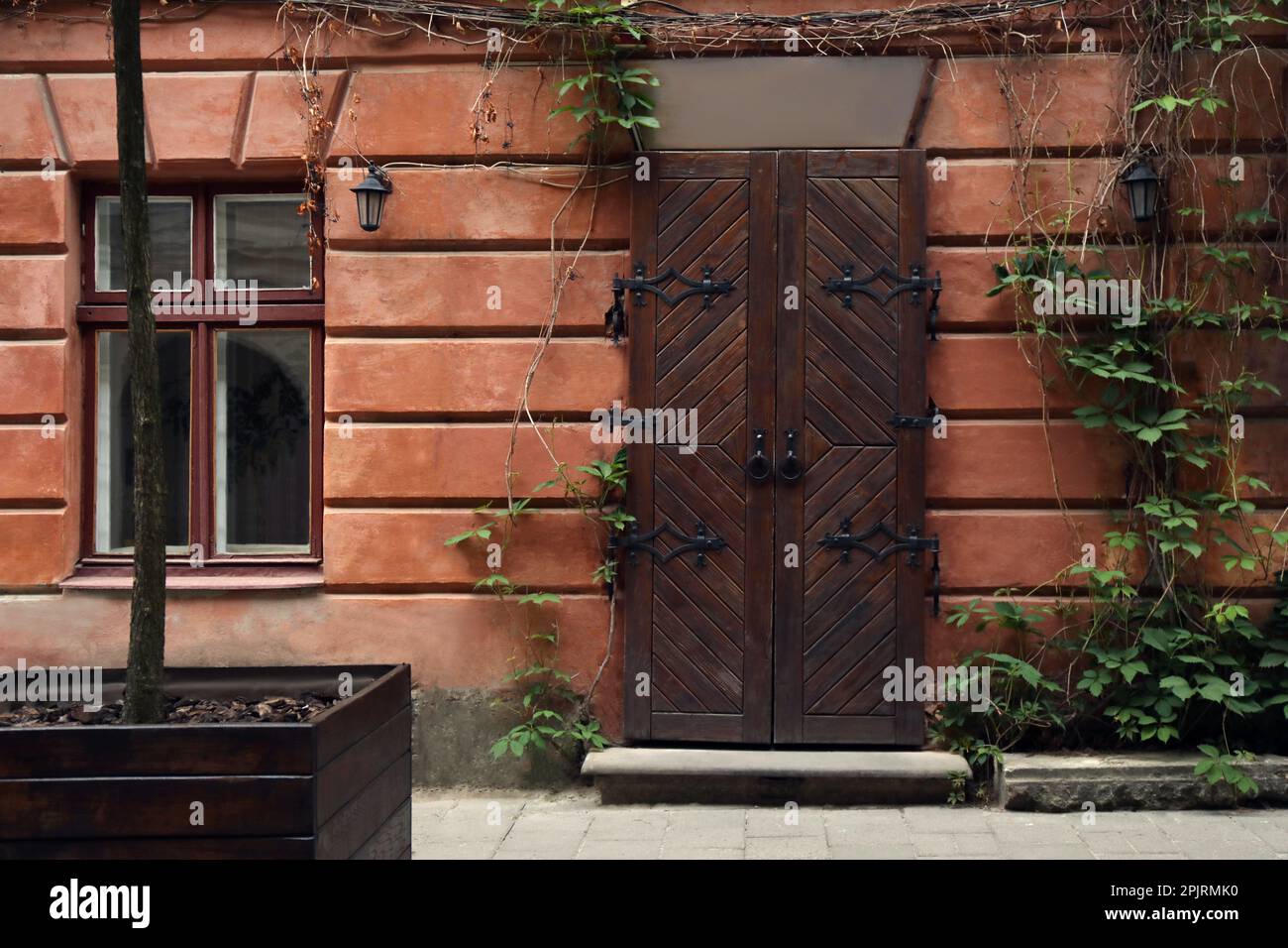 View of building with vintage wooden door and window. Exterior design ...