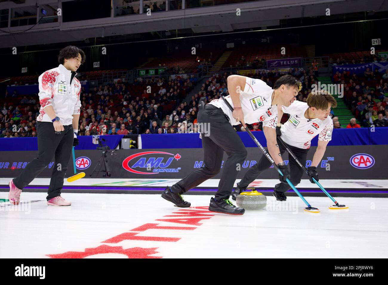 Takeru Yamamoto (L) follows his shot while Tsuyoshi Yamaguchi (C) and