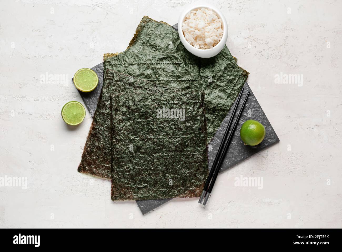 Slate Rice Slate board with nori sheets and rice on light background Stock Photo ...