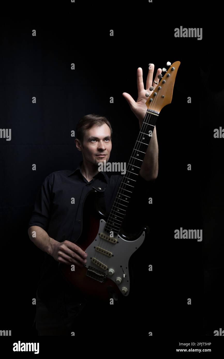 Young male guitarist playing with electric guitar Stock Photo