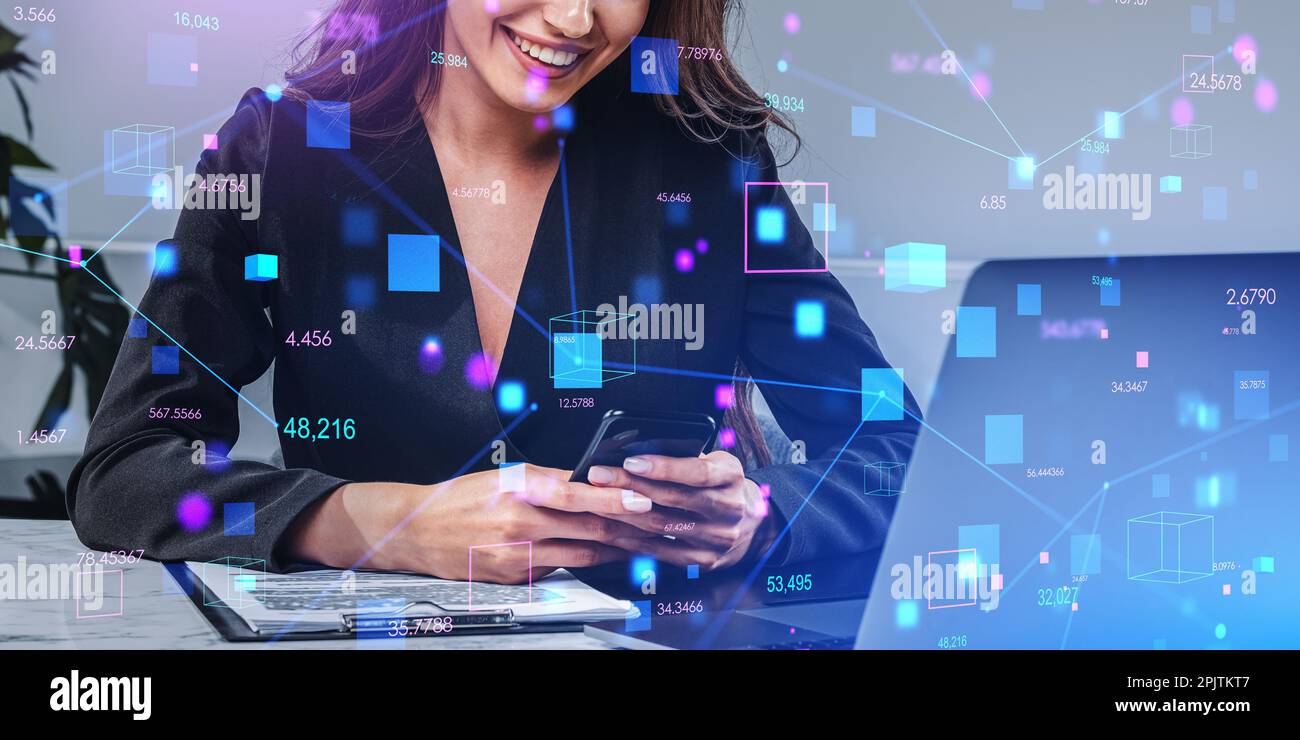 Unrecognizable businesswoman using smartphone and laptop in blurry office with double exposure of immersive blockchain interface. Concept of cryptocur Stock Photo