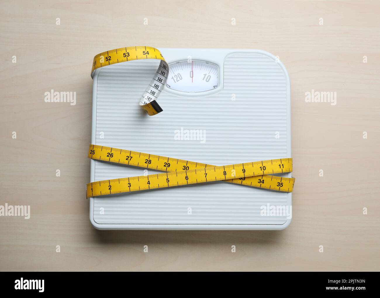 Bathroom scale and coiled tape measure for losing weight to be thinner  Stock Photo - Alamy