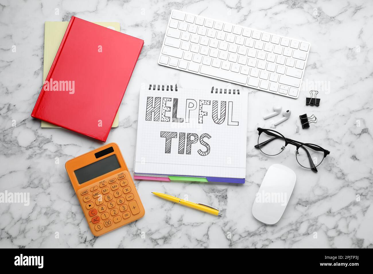 Flat lay composition with text Helpful Tips in notebook on white marble table Stock Photo