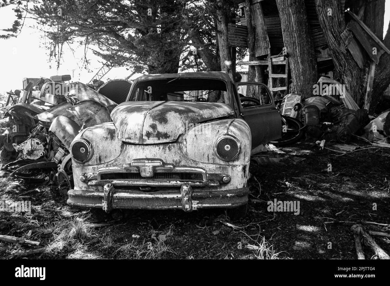Vintage motor car rusting outside at Horopito Auto Wreckers Smash