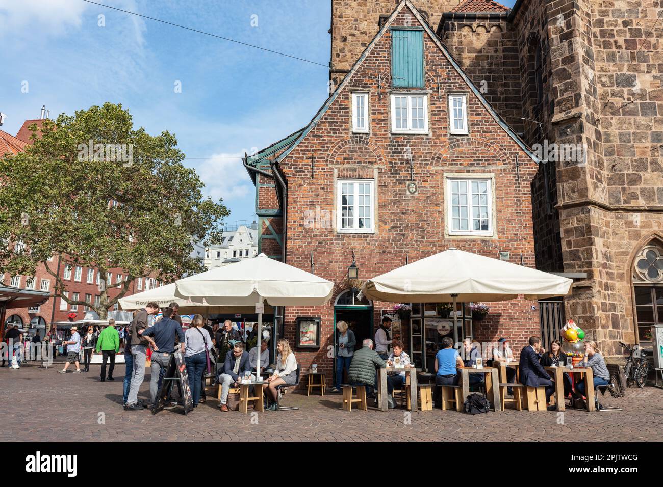 People outside cafe in former pastor's house attached to Church of Our Lady (Liebfrauenkirche) in Unser Liebenfrauen or Our Lady Church Square Stock Photo