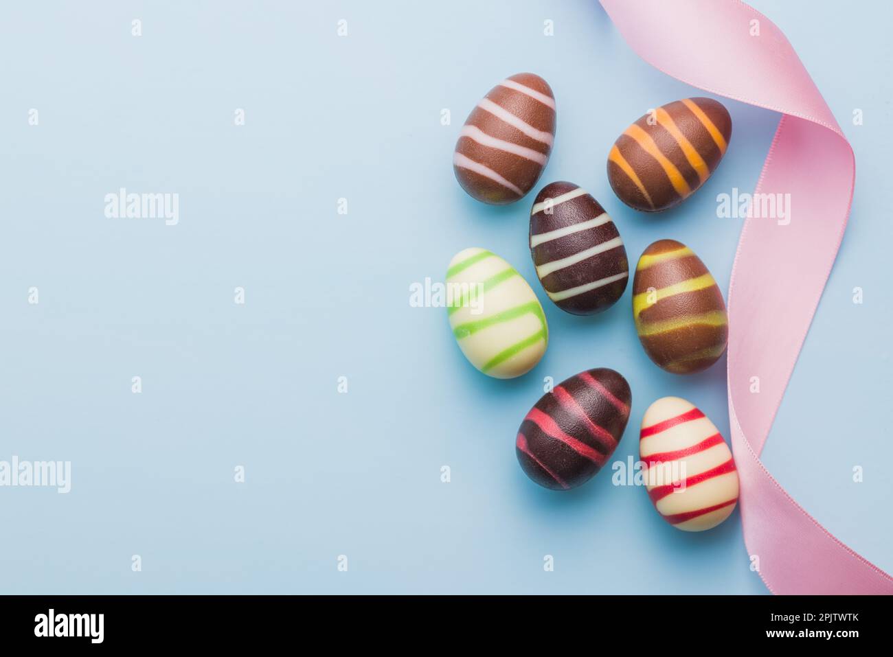 Chocolate easter eggs on the blue background. Top view. Stock Photo