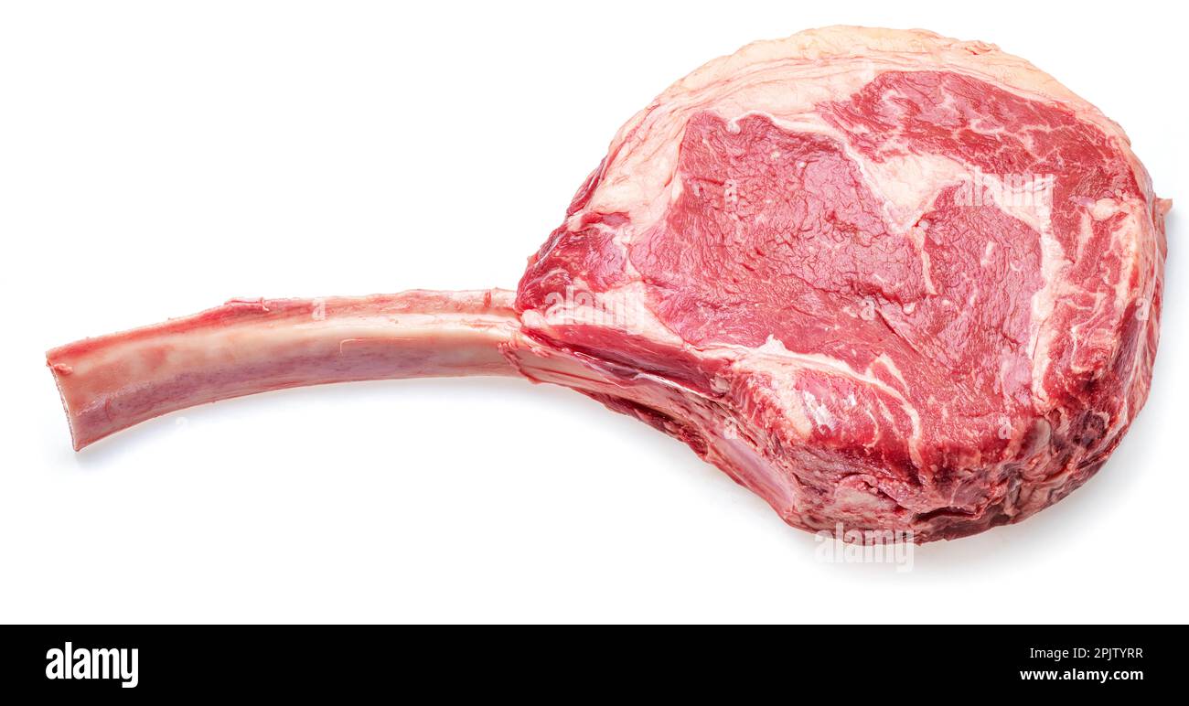Raw rib steak with bone or tomahawk steak isolated on white background. Stock Photo
