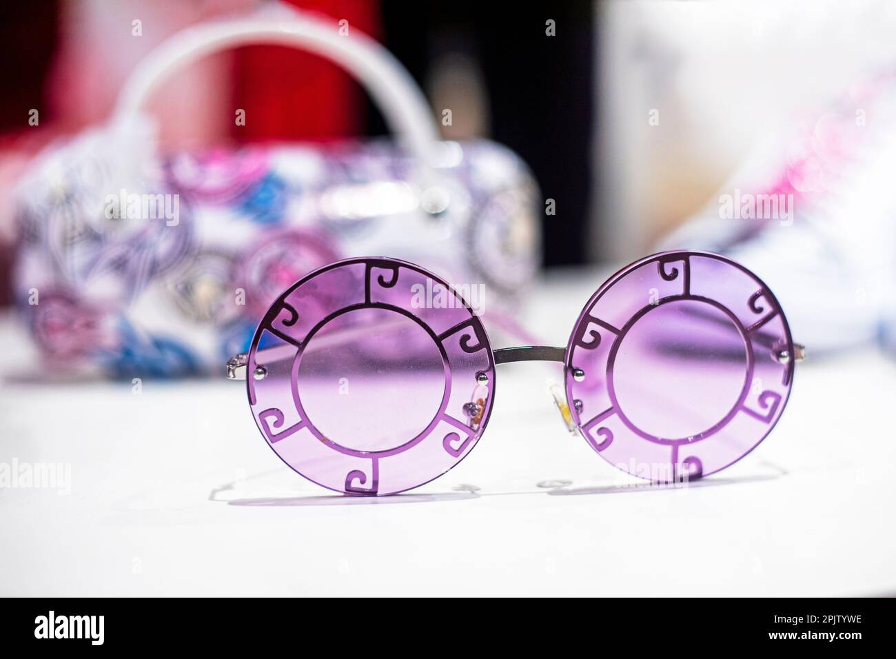 stylish original purple sunglasses on a light background. Summer is coming soon. Stock Photo