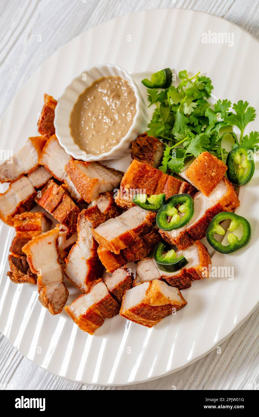 Close Up Of Lechon Kawali Filipino Crispy Fried Pork Belly With Liver Sauce And Fresh Coriander
