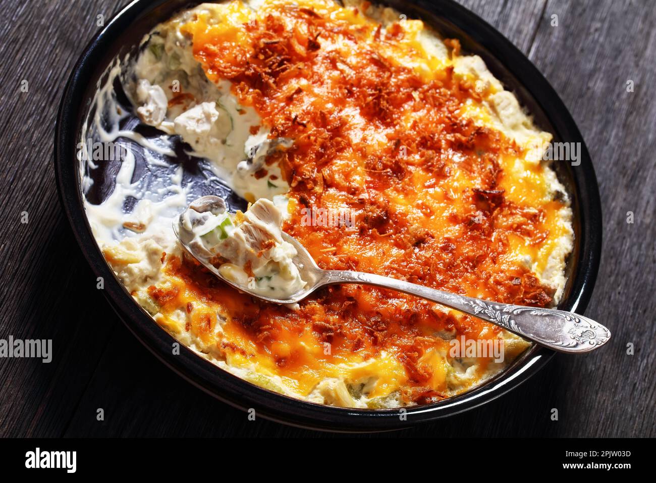 closeup of hot chicken creamy casserole with celery, slivered almonds