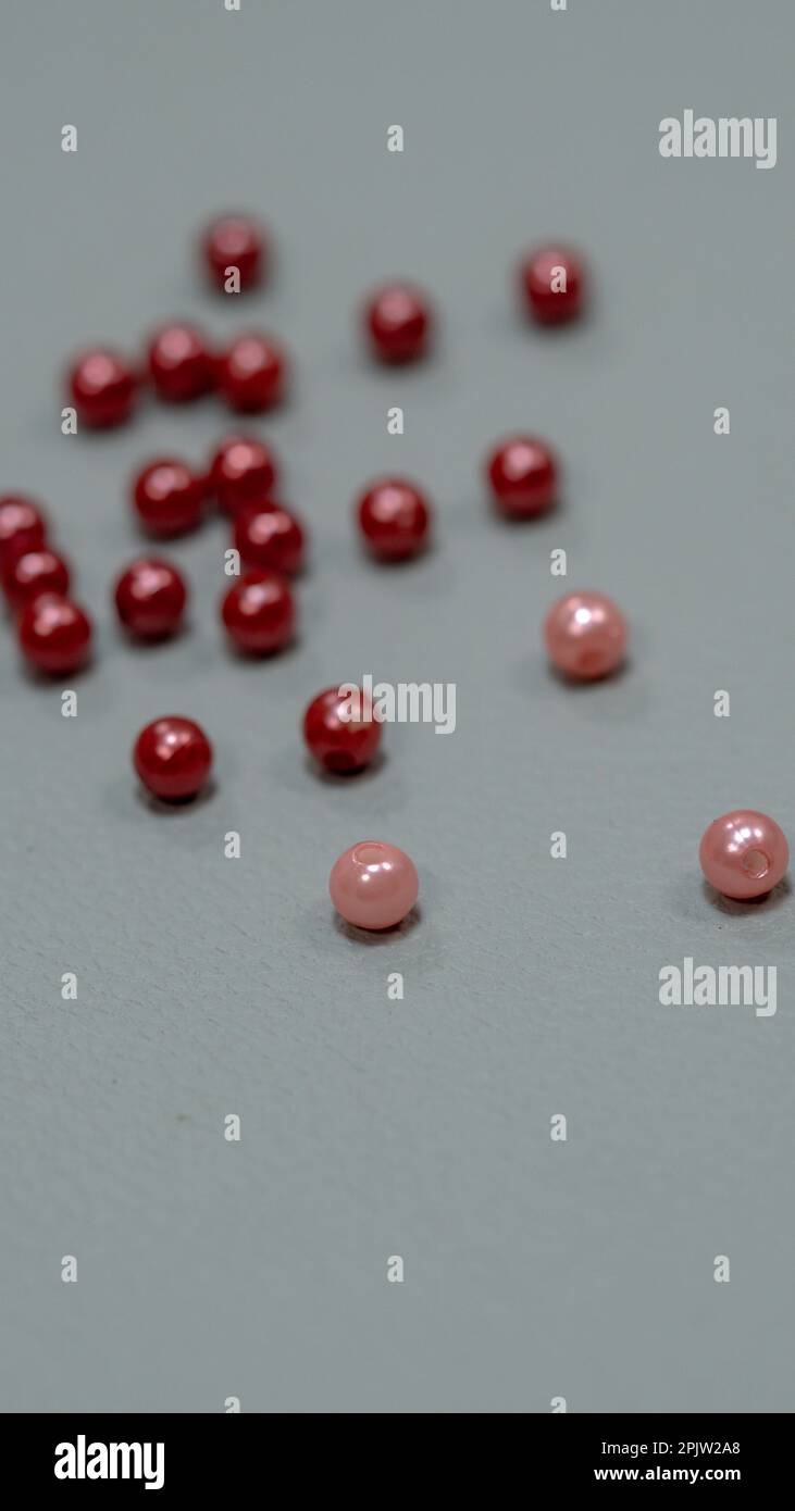 Red beads on a gray background. Shallow depth of field. Stock Photo