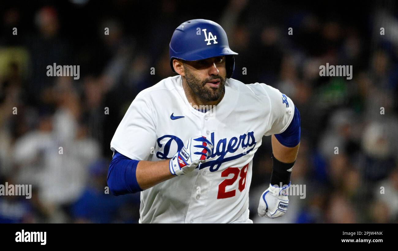 Los Angeles Dodgers' J.D. Martinez runs to first after hitting an RBI