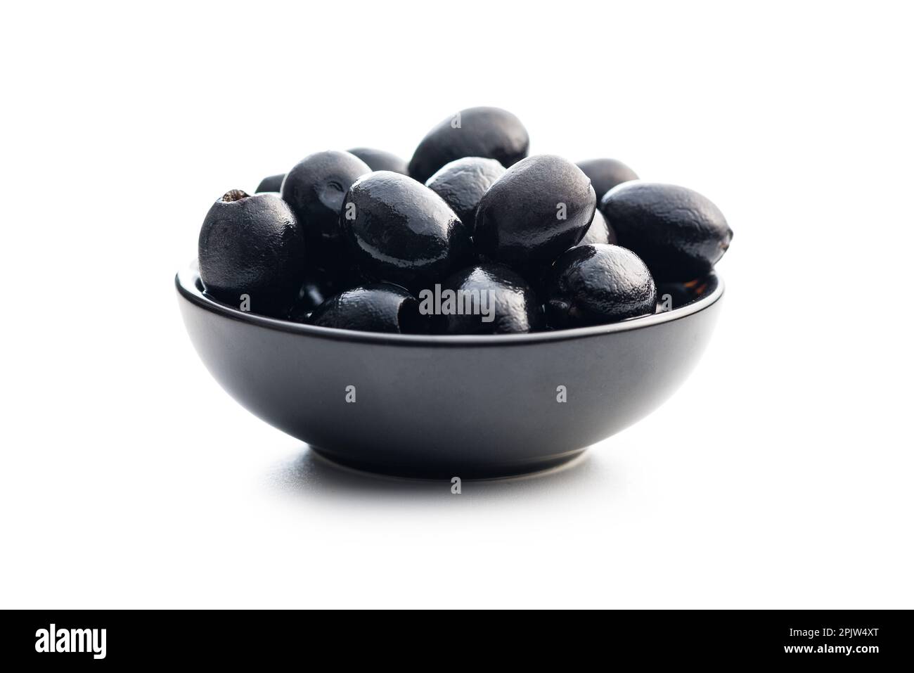 Pitted black olives in bowl isolated on the white background Stock