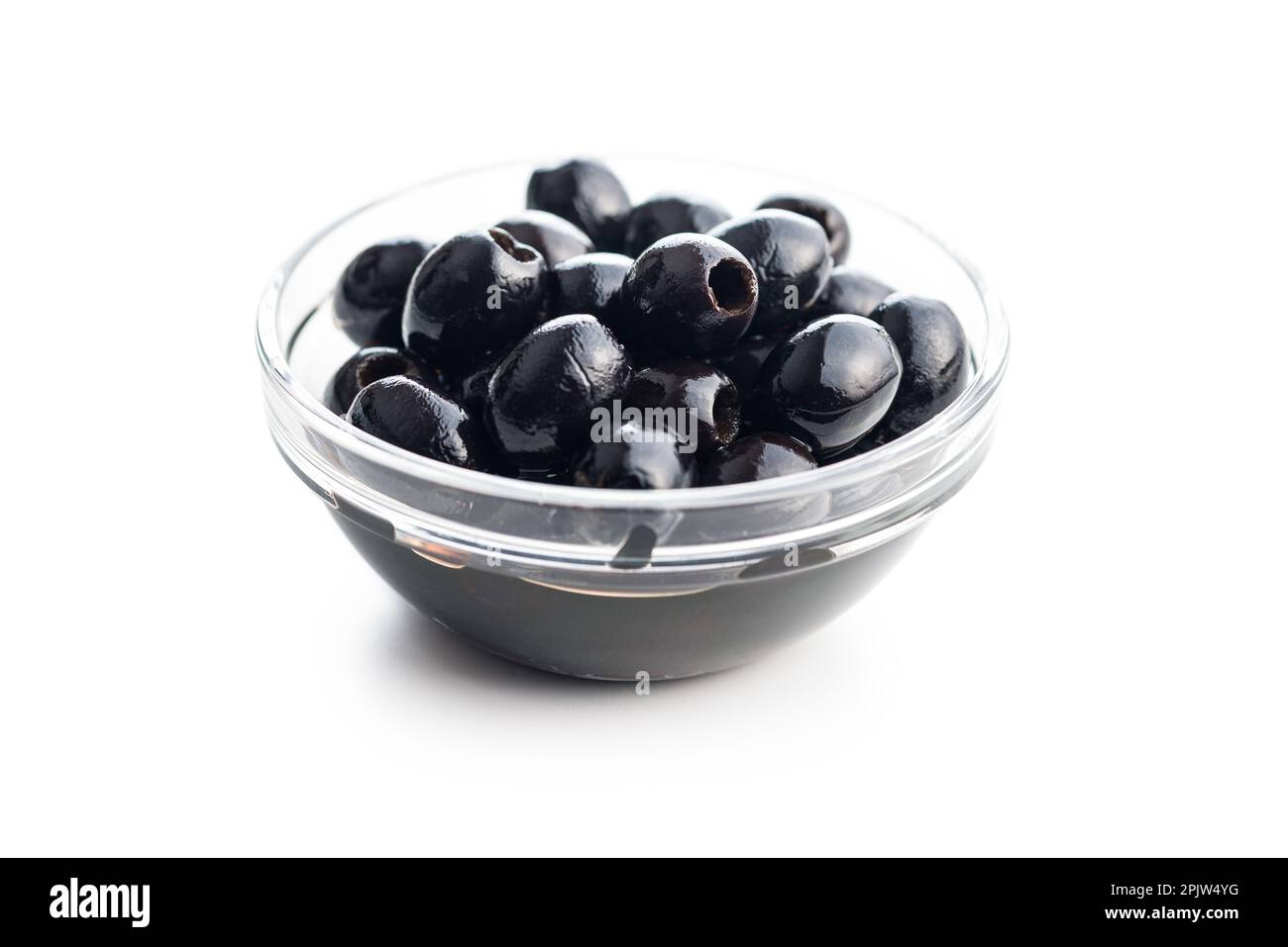 Pitted black olives in bowl isolated on the white background Stock