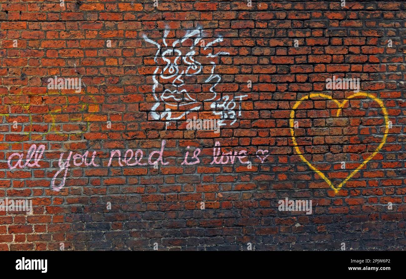 Beatles lyric Graffiti on brick walls in Liverpool - All you need is love Stock Photo