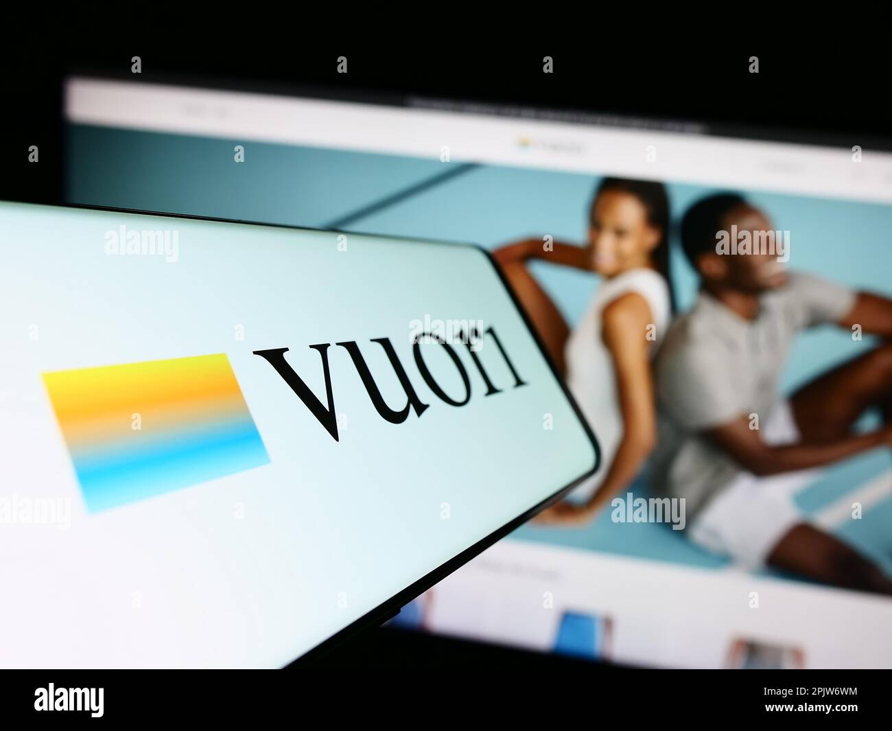 Cellphone with logo of American apparel e-commerce company Vuori Inc. on screen in front of website. Focus on center-left of phone display. Stock Photo