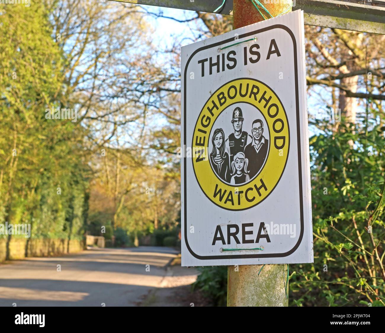 This is a Neighbourhood Watch Area sign scheme on a streetlamp - lack of police means homeowners need to look after their own UK property security Stock Photo