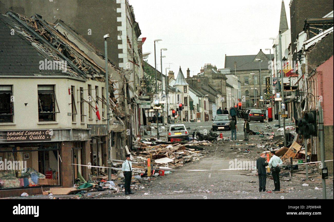 FILE - Royal Ulster Constabulary Police officers stand on Market Street, the scene of a car bombing in the centre of Omagh, Co Tyrone, 72 miles west of Belfast, Northern Ireland, on Aug. 15, 1998. It has been 25 years since the striking of the Good Friday Agreement, the landmark peace accord that ended three decades of violence in Northern Ireland, a period known as “the Troubles.” (AP Photo/Paul McErlane, File) Stock Photo