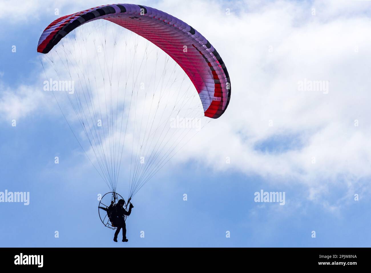 Paraglider against blue sky. Stock Photo