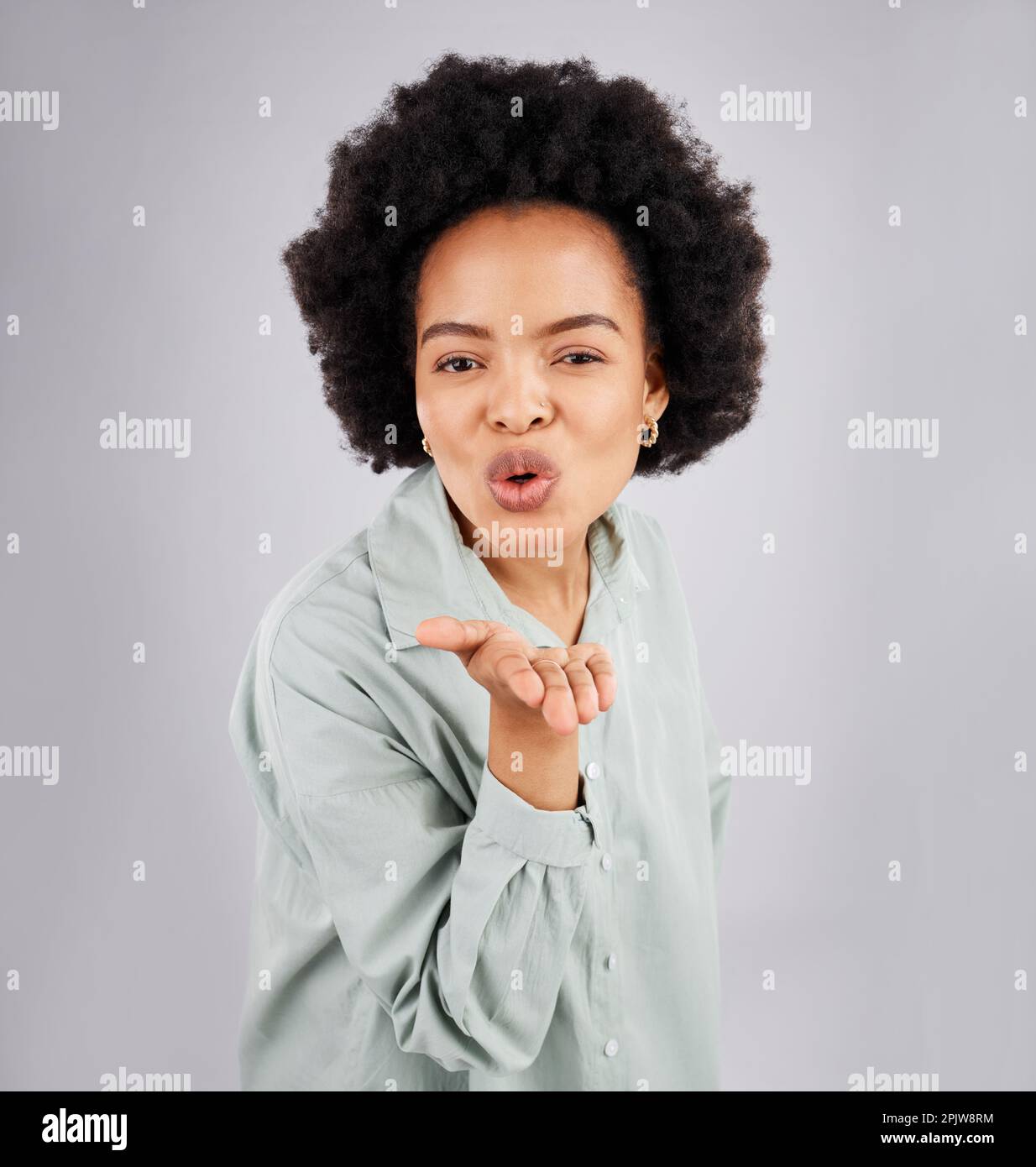 Portrait, woman and blowing kiss in studio, white background and backdrop of love, care or flirt. Face of happy female model, hands and kissing emoji Stock Photo