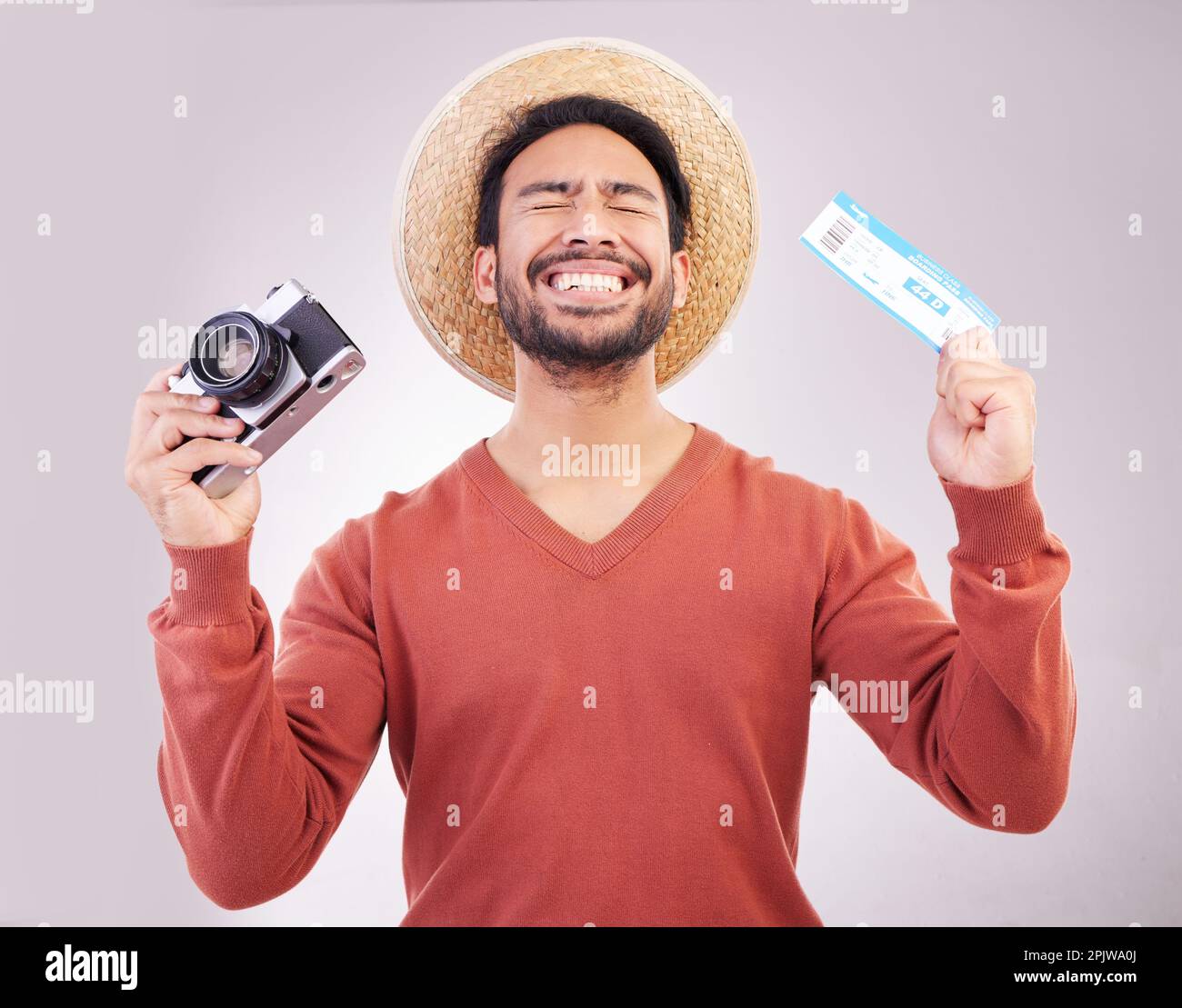 Ticket, camera and excited man in studio with paperwork for holiday, adventure and fun hat on white background. Smile, travel and happy person with Stock Photo