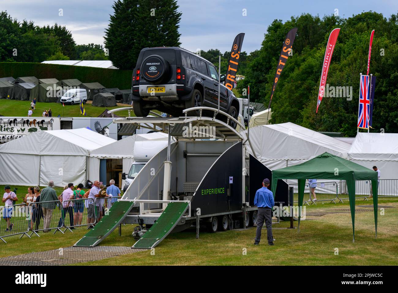 Defender drives on challenging temporary off-roading showground course (visitors) - L R Experience, Great Yorkshire Show 2022, Harrogate, England, UK. Stock Photo