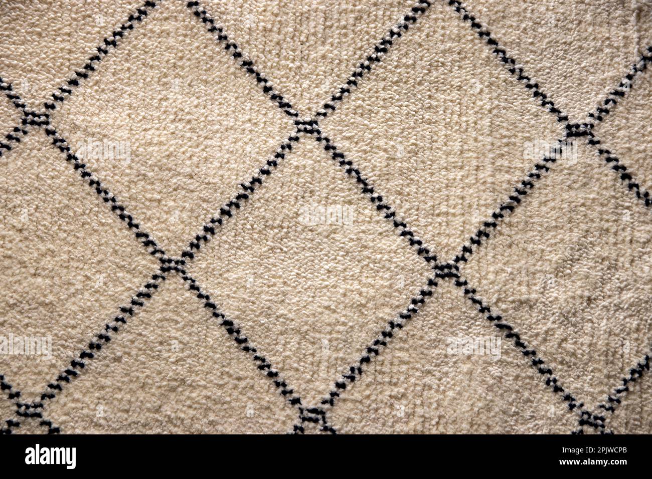 Beige fabric texture. Closeup of a light brown carpet textile