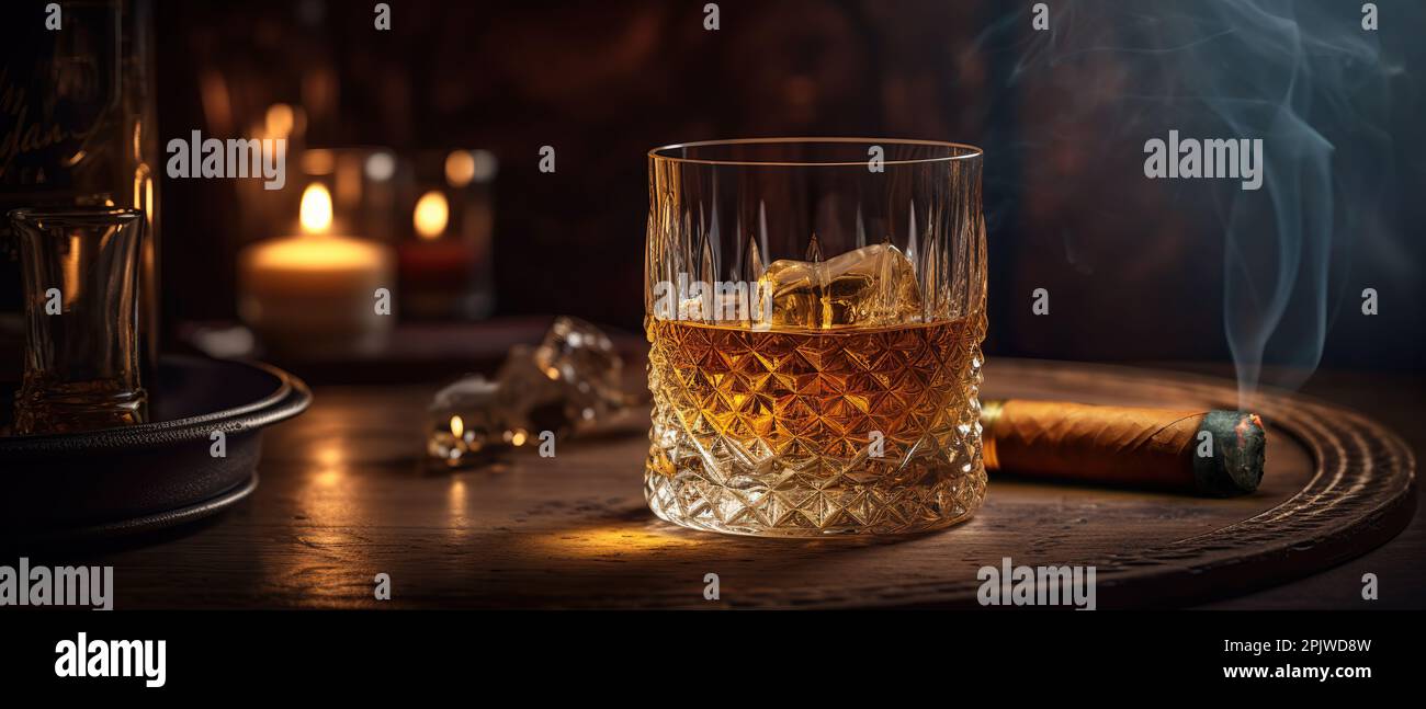 A glass of whiskey with ice and a Cuban cigar on a wooden table on a dark background. Men's club banner idea. Copy space for text Stock Photo