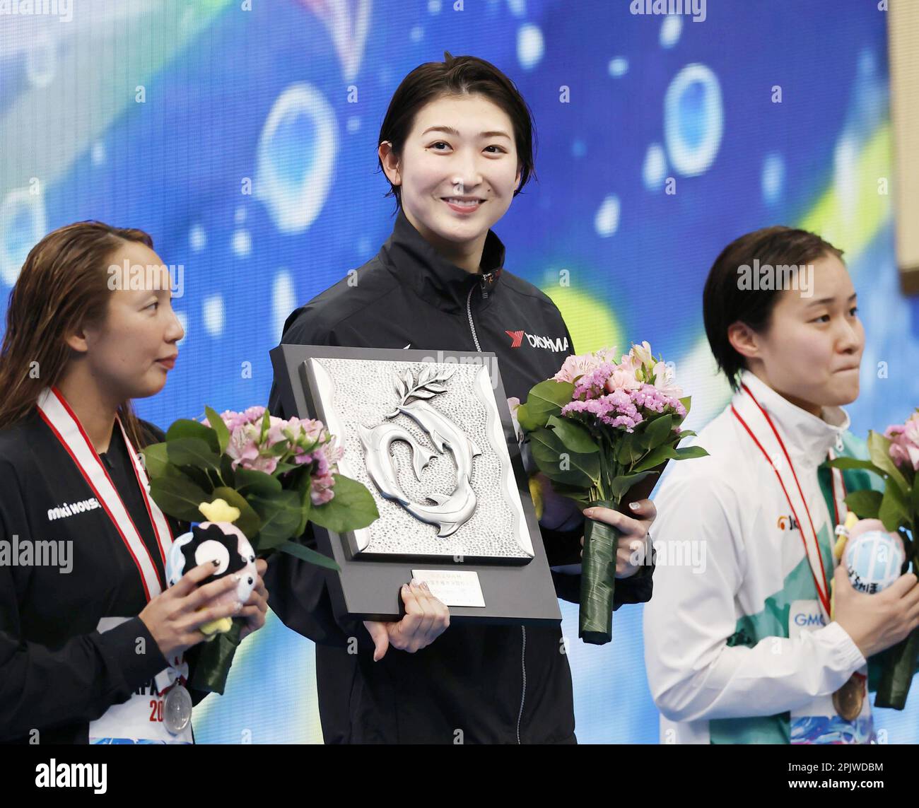 Tokyo, Japan, April 4, 2023. Leukemia survivor Rikako Ikee (C) stands on  top of the podium after winning the women's 100-meter butterfly at the  national swimming championships, qualifying for this summer's worlds,