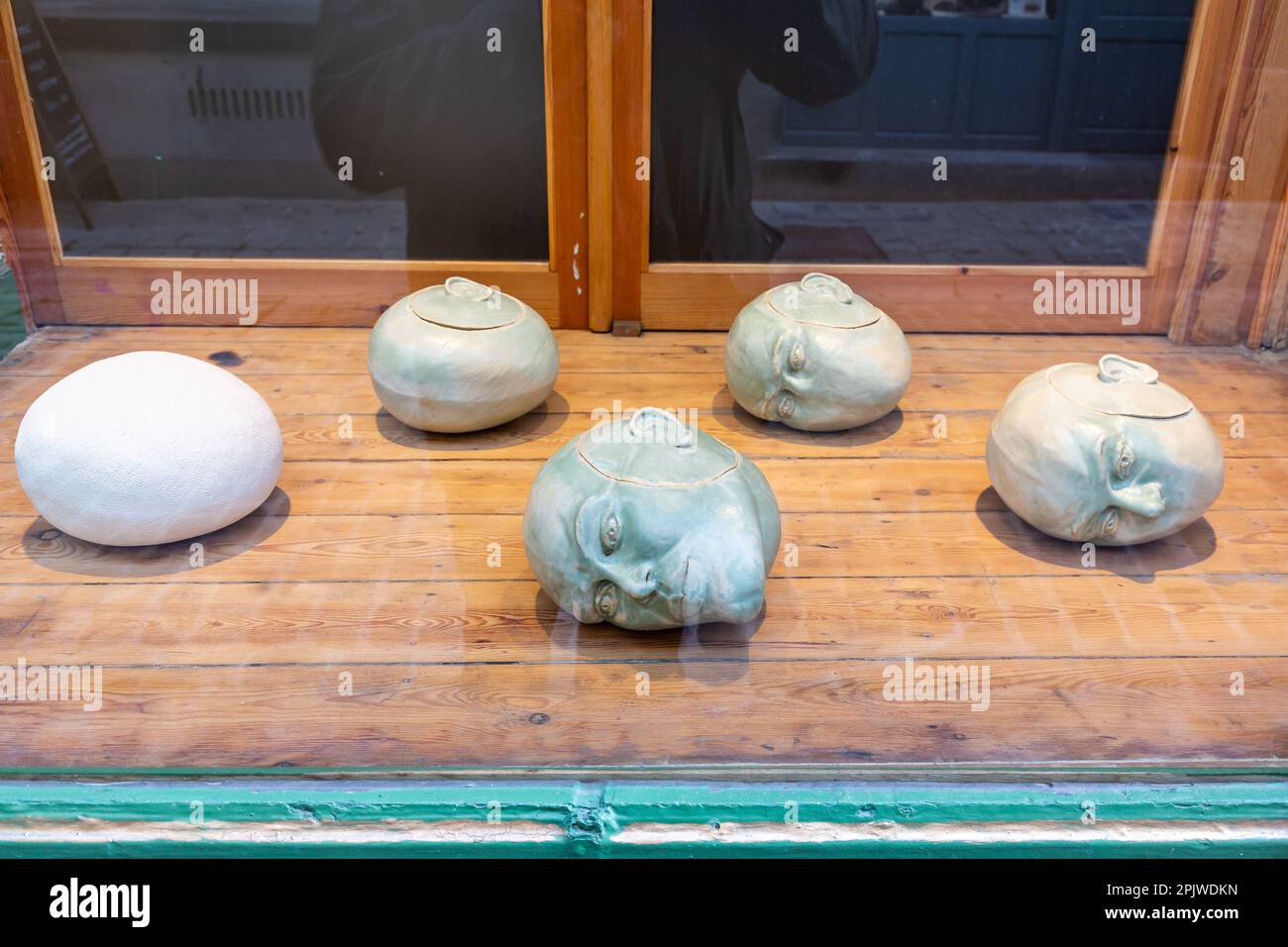 Boxes in the shape of human heads, displayed in the front of a store in Brussels. Stock Photo