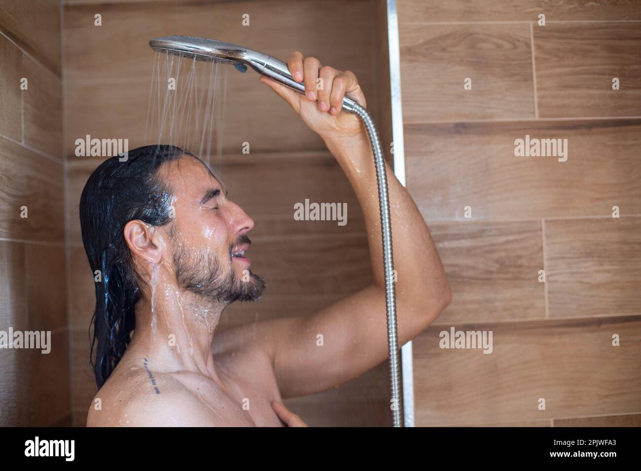 Long hair man showering hi-res stock photography and images - Alamy