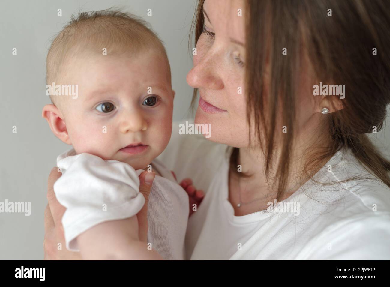 Loving and affectionate mother holding newborn baby Stock Photo
