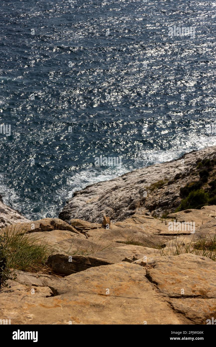 Rock and the sea. Calm water of the sea, dark blue color.  Giola lagoon, Tassos (Thassos) island, Greece. Stock Photo