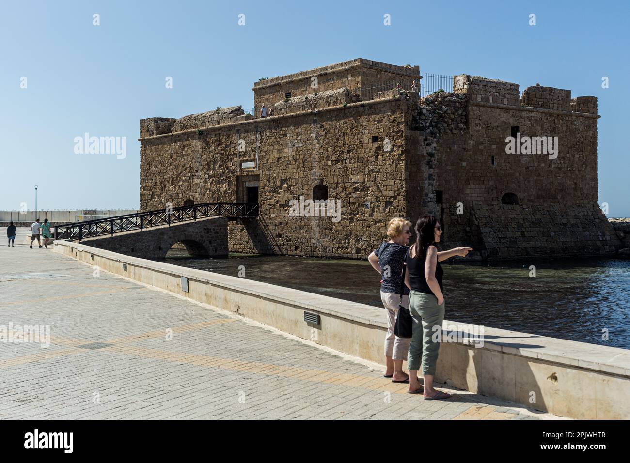 Tourists are seen in front of the castle at the port of Paphos, Cyprus, on Apr. 4, 2023. Cyprus sees massive increase in tourist arrivals in February with UK topping the list. Tourist arrivals in Cyprus increased by 65.6% year-on-year in February 2023. This fact, combined with the facts that Cyprus welcomed 3.2 million tourists last year, despite the absence of 800,000 Russian and Ukrainian tourists because of the war and that for 2022 it is estimated that tourists' spending has increased by about 13% on average for each trip, makes 2023 seem very promising. (Photo by Kostas Pikoulas/Sipa USA) Stock Photo