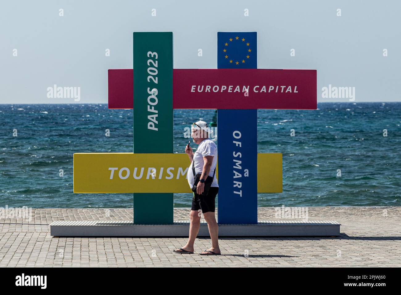 April 4, 2023, Paphos, Paphos, Cyprus: A tourist walks in front of an installation about Paphos smart tourism project. Cyprus sees massive increase in tourist arrivals in February with UK topping the list. Tourist arrivals in Cyprus increased by 65.6% year-on-year in February 2023. This fact, combined with the facts that Cyprus welcomed 3.2 million tourists last year, despite the absence of 800,000 Russian and Ukrainian tourists because of the war and that for 2022 it is estimated that tourists' spending has increased by about 13% on average for each trip, makes 2023 seem very promising. (Cred Stock Photo
